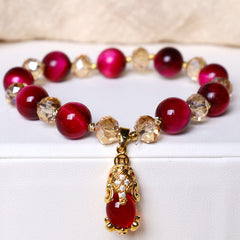 Red Tiger Eye PiXiu Bracelet – Bracelet on white display stand showing red tiger eye and crystal beads