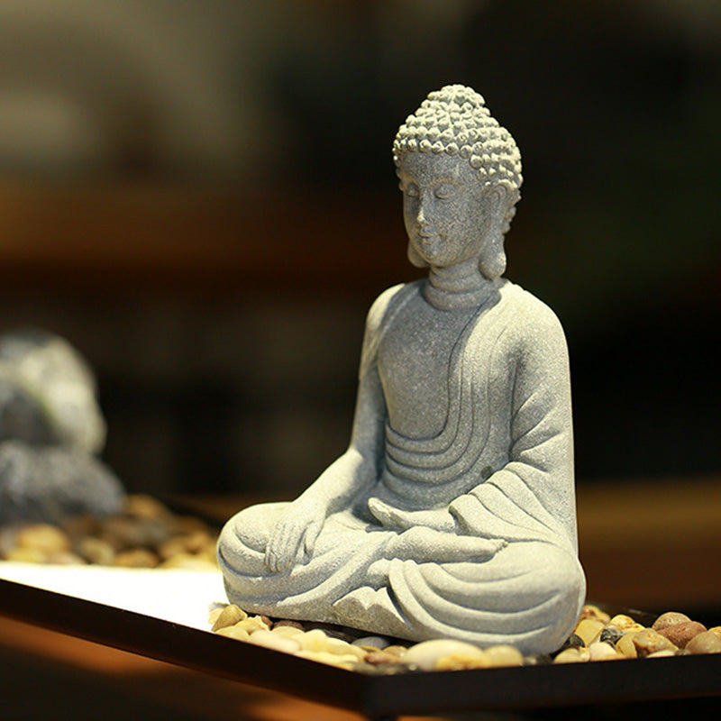 Sitting Meditation Buddha Sandstone Statue – three-quarter on pebbles, dhyana mudra, zen serenity