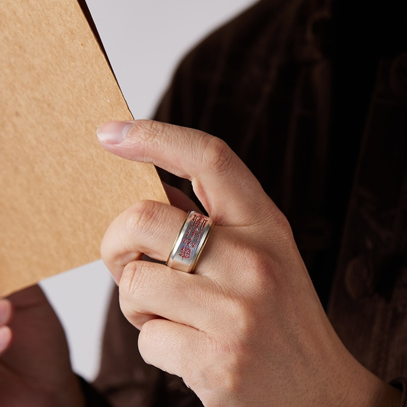 Wu Lu Cai Shen Ring – worn on hand holding craft paper showing fit, red engraved wealth talisman band