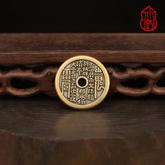 Vajra Knot Shan Gui Keychain – antiqued brass coin on carved dark wood stand, black backdrop, red seal logo, spiritual amulet keychain