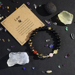 Zodiac Crystal Bracelet – Leo on dark surface with scattered crystals and raw mineral specimens