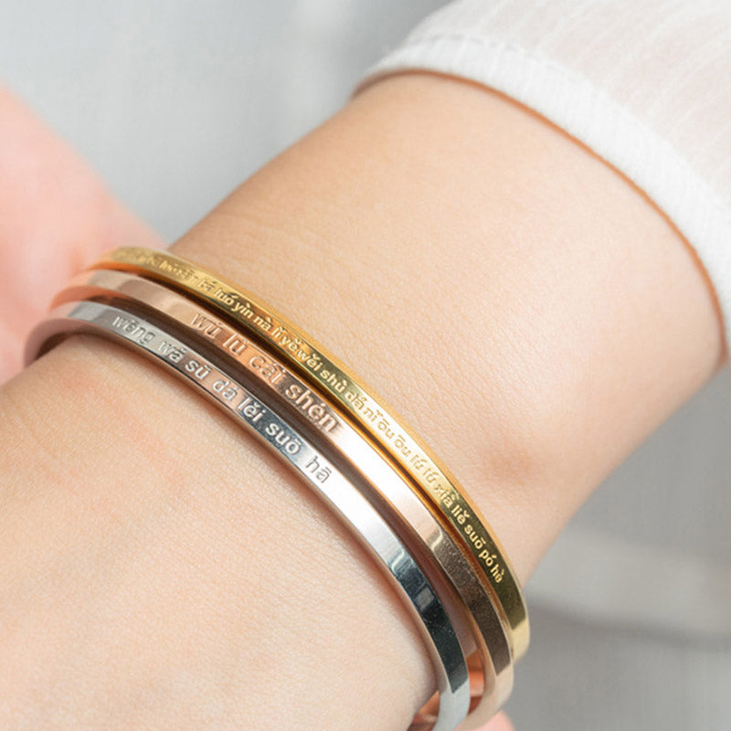 Om Mani Padme Hum Engraved Bracelet – three stacked cuffs worn on wrist, layered mantra jewelry