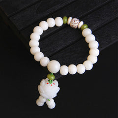 Bodhi Seed Lotus Bracelet – Smooth white prayer beads with speckled focal bead and red-accented lotus charm