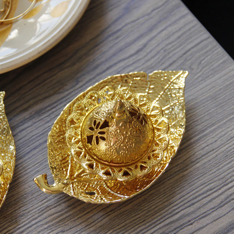 Tibetan Gold Leaf Coaster Incense Burner – Gold dome with filigree cutout lid resting on leaf base tray, metal incense burner