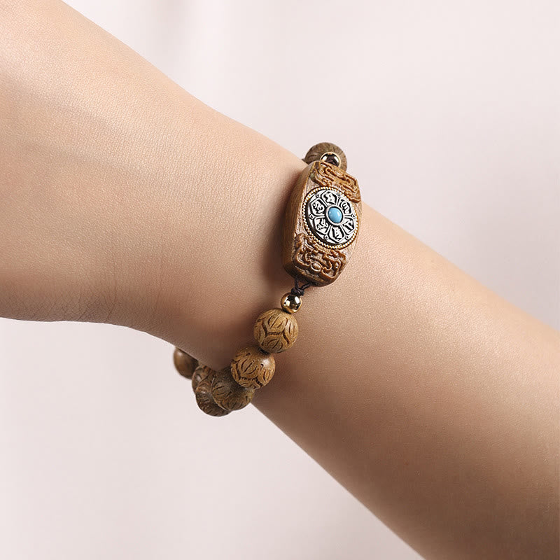 Green Sandalwood & Ebony Soothing Bracelet – worn on wrist showing carved wood beads and turquoise stone inlay, men’s medi...