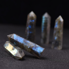 Natural labradorite crystal pillars displayed with two lying down, black background, healing stone points with blue shimmer