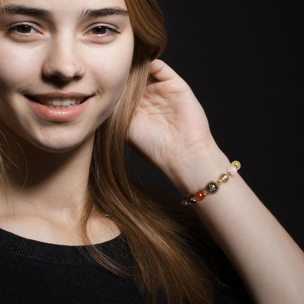 Zodiac Crystal Bracelet – Leo worn on wrist showing colorful gemstone beads, studio shot