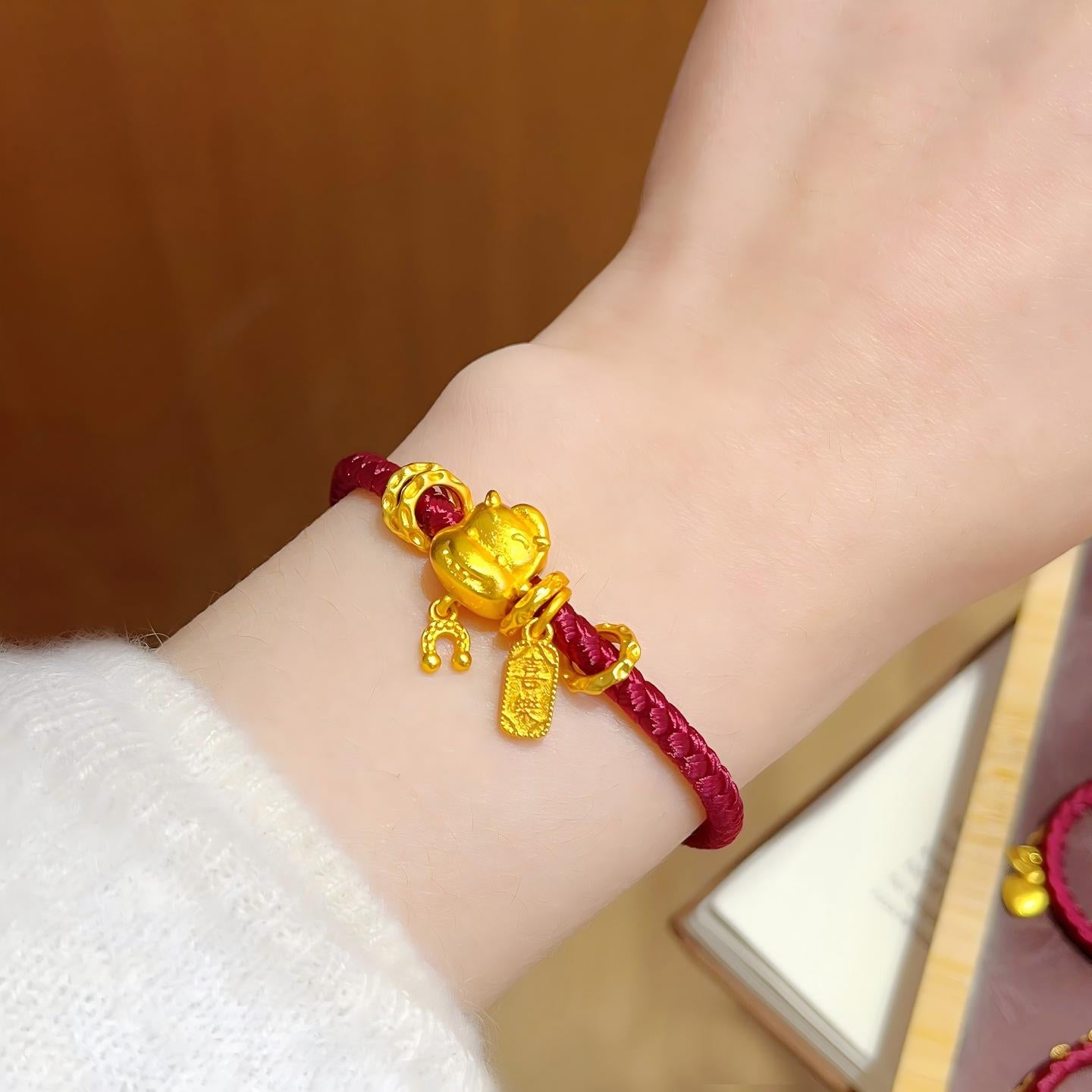 Ben Ming Nian Bracelet – gold rat charm worn on wrist with white sweater, warm lifestyle photo