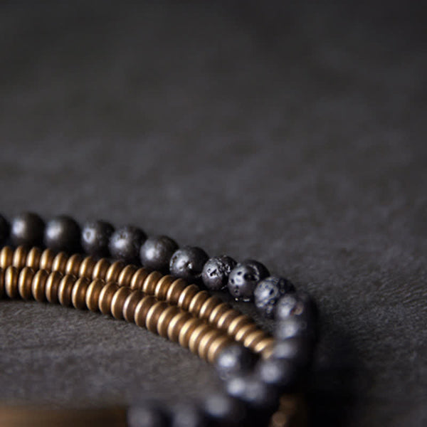 Lava Rock Copper Healing Bracelet – Black volcanic bead bracelet with copper center and silver metal accents, white background e-commerce product photo front view