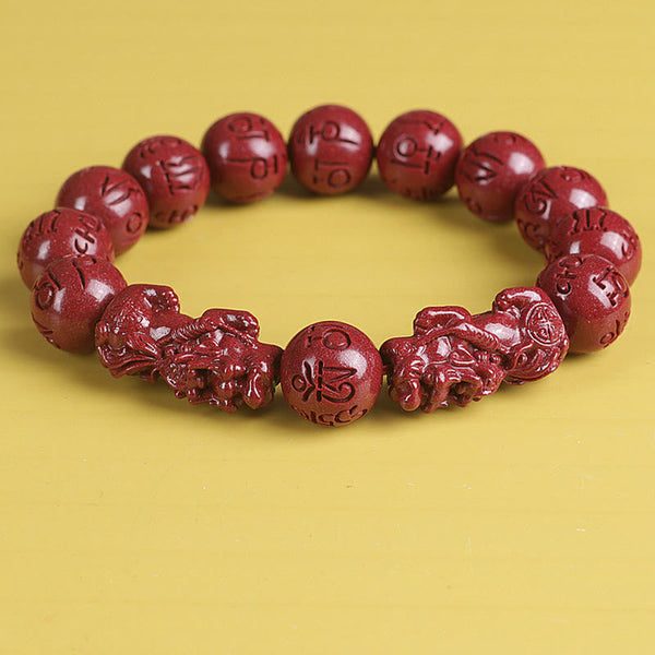 Double PiXiu Cinnabar Bracelet – Slightly angled front view of red cinnabar PiXiu bracelet, prosperity jewelry