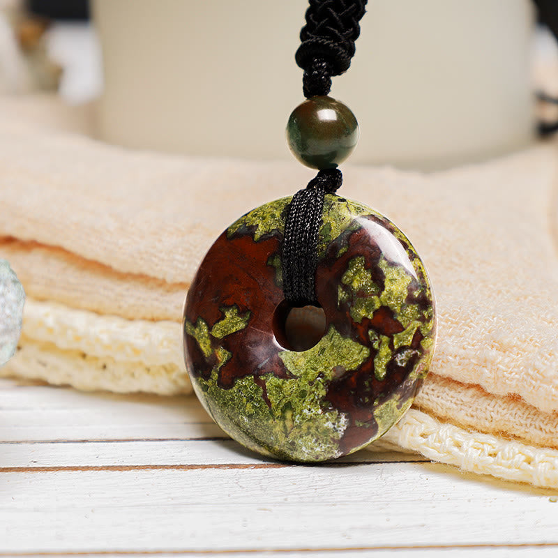 Lucky Coin Pendant Healing Crystal Gemstone Necklace – Green and red-brown bloodstone necklace worn over white shirt and brown jacket