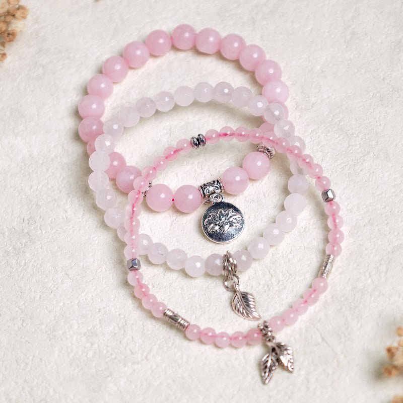 Crystal Lotus Bracelet – mixed-size rose quartz and white crystal beads with silver leaf and lotus pendants, boho jewelry