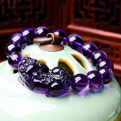 Amethyst PiXiu Fortune Bracelet – Amethyst bracelet on green ceramic vessel, feng shui wealth charm