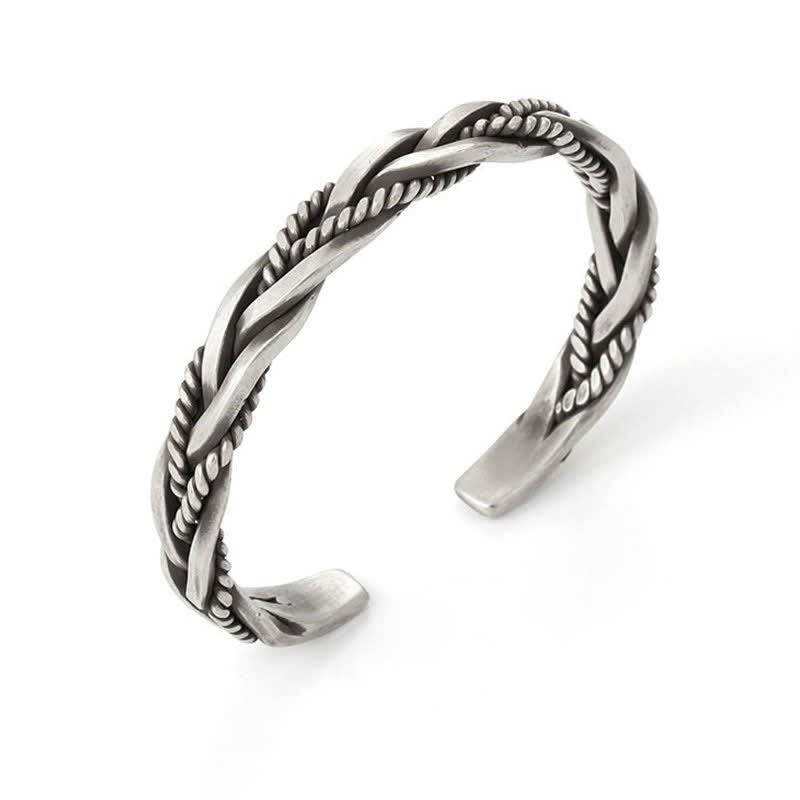 Viking twisted braided bracelet on white background with double-strand braid rope-textured inlay and oxidized antique silver finish showing open cuff terminals