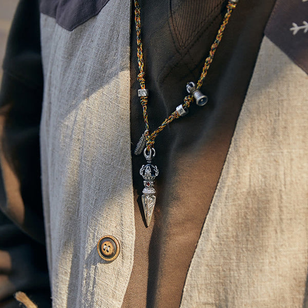 Dorje Vajra Pendant – Worn close-up with layered vest in golden-hour light, ethnic pendant necklace