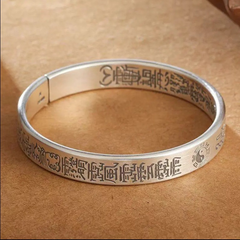 Antique Tai Chi Bracelet – flat lay on tan surface showing full engraved circle with Tai Chi, protection amulet