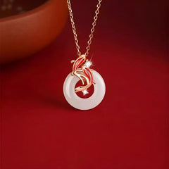 Koi Fish Peace Pendant – rose gold koi with white jade disc and diamonds on red background, luck harmony
