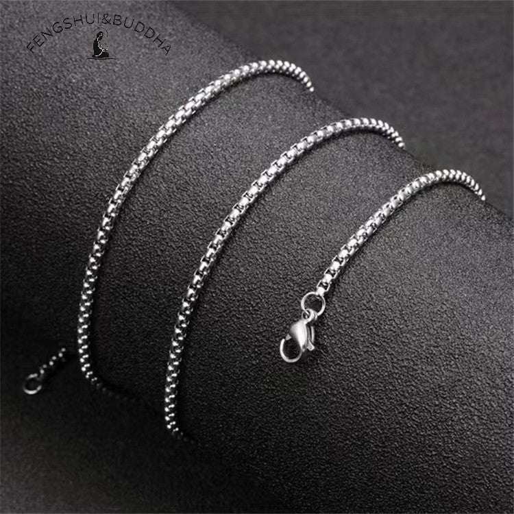 Zodiac Spin Necklace – silver box chain close up, black textured background with lobster clasp visible, stainless steel chain