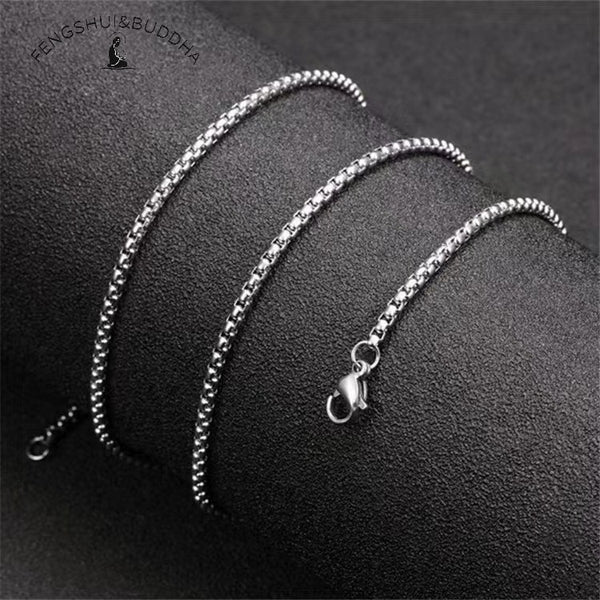 Zodiac Spin Necklace – silver box chain close up, black textured background with lobster clasp visible, stainless steel chain