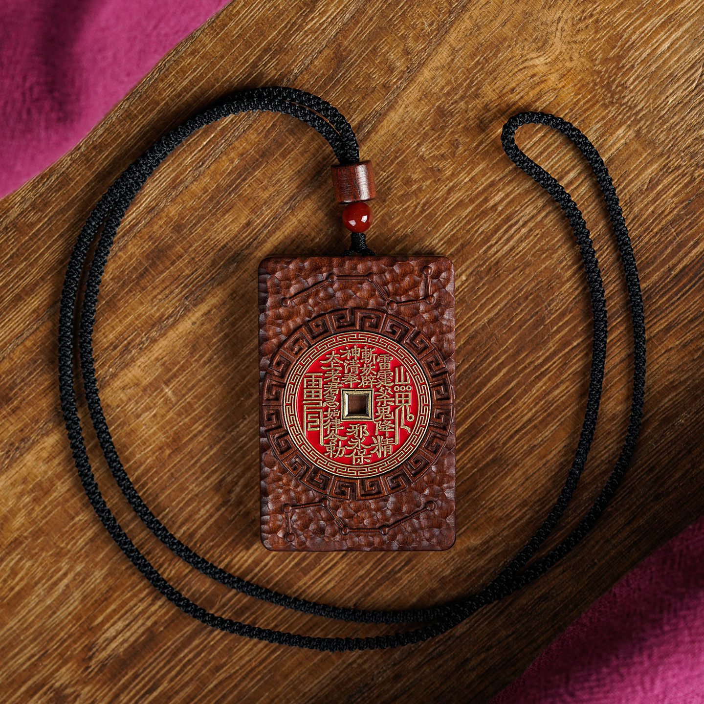 Shan Gui Wood Pendant – pendant on wooden tray black cord loop, red bead accent shown