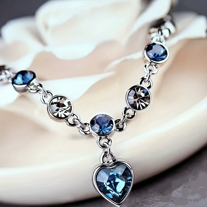 Heart of Ocean Bracelet – heart pendant and blue crystals on cream ceramic dish, gift-ready elegance