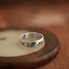 Koi Cloud Ring – Silver ring on dark wooden stand showing blue koi red cloud enamel, Chinese luck protection jewelry