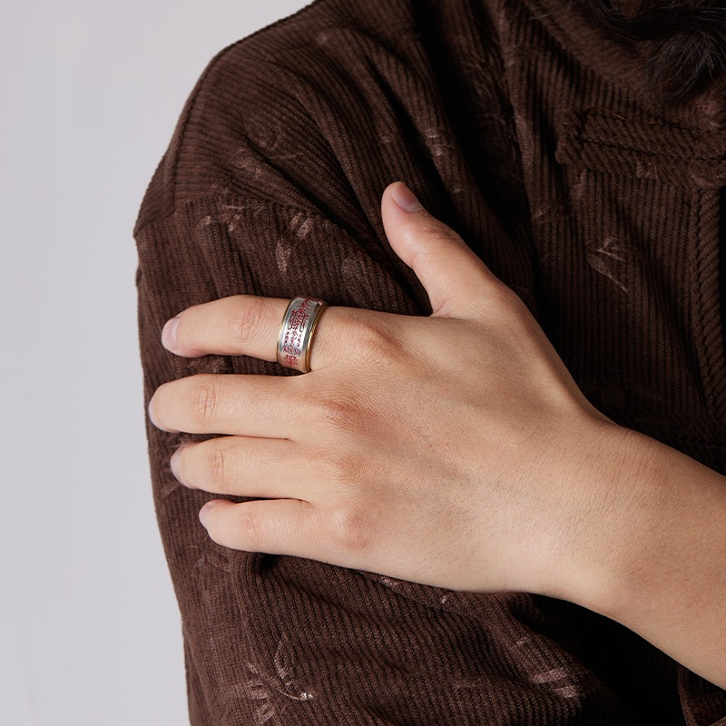 Wu Lu Cai Shen Ring – lifestyle shot on hand over brown corduroy, gold-edged silver wealth ring