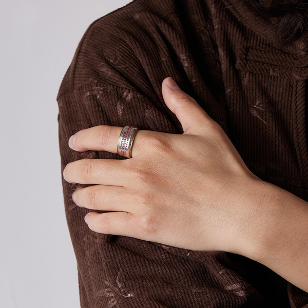 Wu Lu Cai Shen Ring – lifestyle shot on hand over brown corduroy, gold-edged silver wealth ring