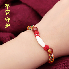 Kids Zodiac Bracelet – red cord with dog tooth and cinnabar beads on child wrist, safe guardian charm