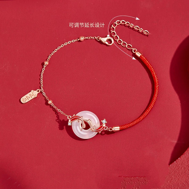 Koi Bracelet – Flat lay on red showing adjustable extender chain with Chinese text, jade crystal luck bracelet