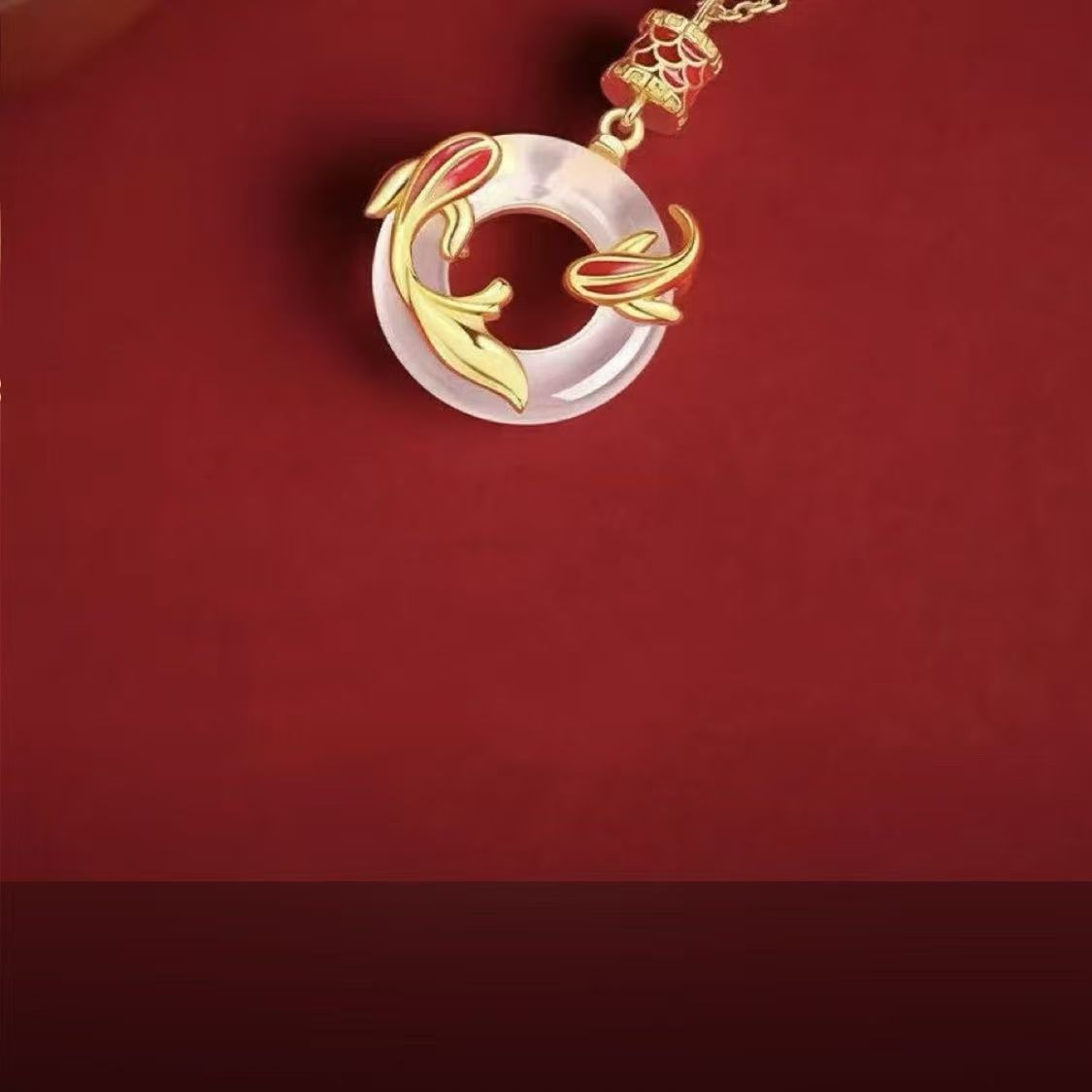 Koi Peace Necklace – top-down view of gold koi charm on white jade ring with red accent, spiritual necklace