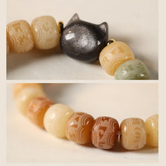 Bodhi Seed Cat Head Bracelet – Macro detail of silver-sheen black cat charm bead beside carved bodhi seed beads, Buddhist charm bracelet