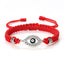 Red cord evil eye bracelet with silver crystal evil eye charm on white background