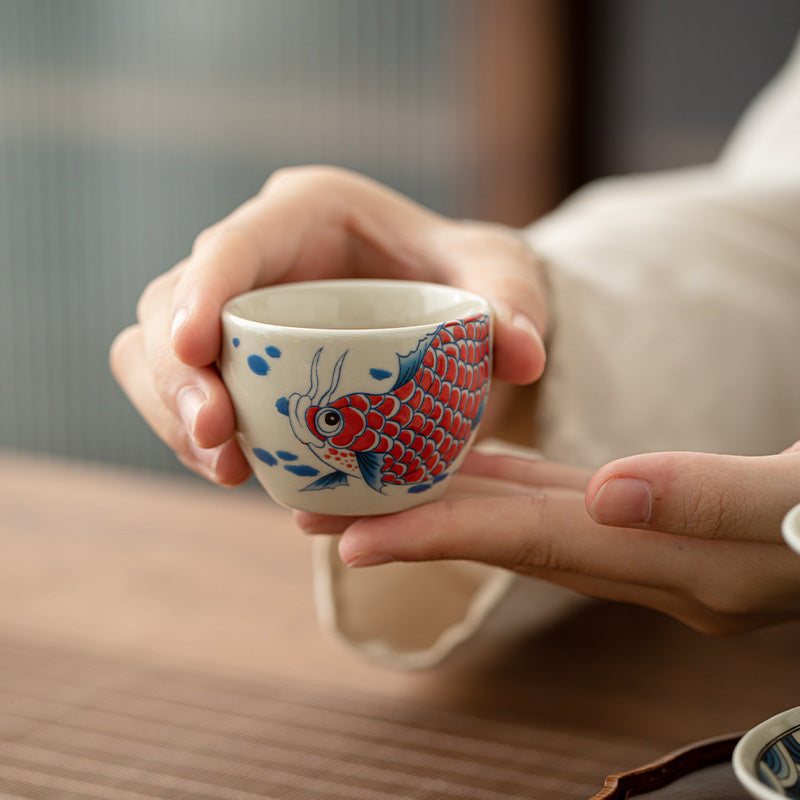 Koi Arowana Peony Teacup – front view with koi and peony painting, ceramic tea cup
