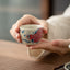 Koi Arowana Peony Teacup – front view with koi and peony painting, ceramic tea cup