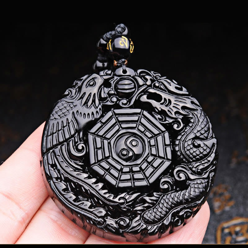 Bagua Dragon Phoenix Obsidian Pendant – Handheld view showing carving depth, meaningful