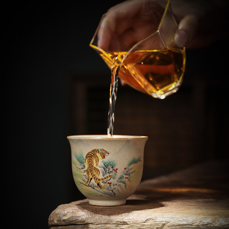 Chinese Zodiac Ceramic Teacup - amber tea pouring into tiger zodiac cup, tea ceremony ritual