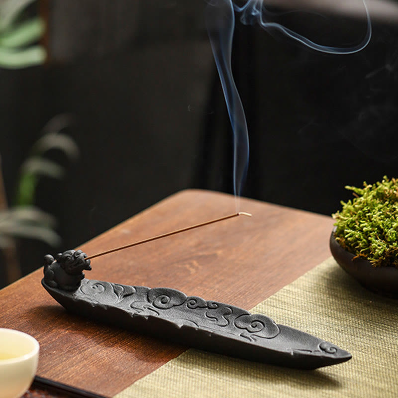 Dragon-head incense holder with rising smoke, white tea cup, moss bowl, dark bokeh background – ceramic cloud-pattern incense burner