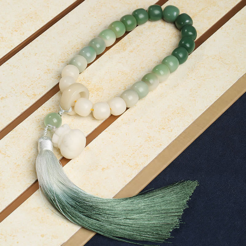 Bodhi Seed Lotus Wisdom Wrist Mala – Ombre jade bead bracelet with lotus pendant and green tassel on decorative box, fortune jewelry