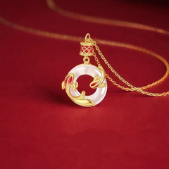 Koi Peace Necklace – gold chain and koi fish wrapped around white mother-of-pearl disc, elegant gift
