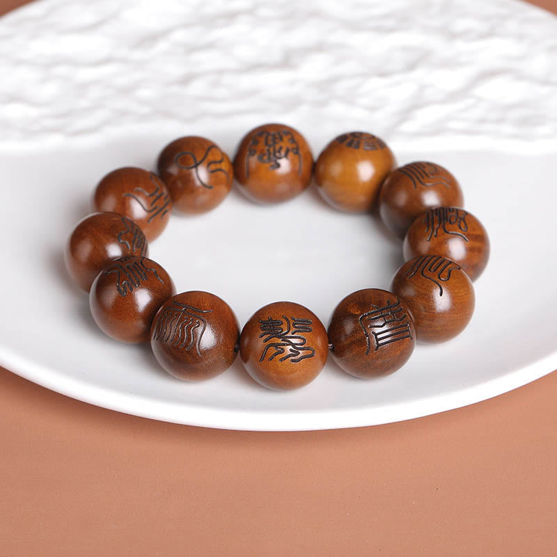 Lightning Struck Jujube Wood Taoist Scripture Bracelet - Engraved wood bracelet on white textured plate, Chinese scripture jewelry