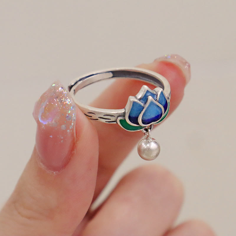 Lotus Flower Copper Ring - silver adjustable lotus with blue enamel held between fingers, healing