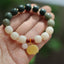 Gradient Bodhi Seed Amber Lotus Bracelet – green-to-cream ombré beads with carved amber lotus on palm, Serene