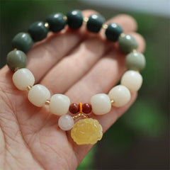 Gradient Bodhi Seed Amber Lotus Bracelet – green-to-cream ombré beads with carved amber lotus on palm, Serene