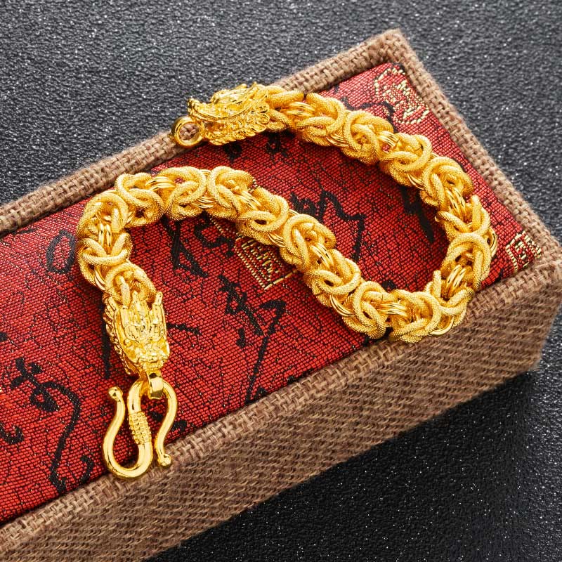 Dragon Protection Bracelet - Gold chain on red cushion with S-hook clasp visible, Luck