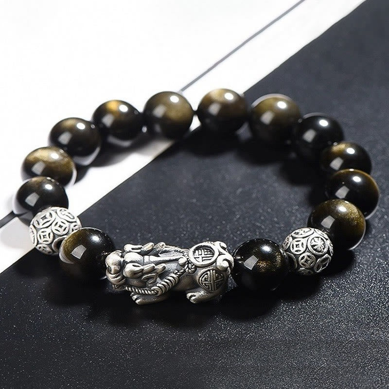 Gold Sheen Obsidian PiXiu Bracelet – Angled view of gold sheen obsidian beads with PiXiu on black surface