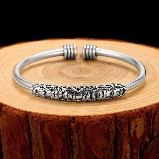 Om Mani Padme Hum Cuff Bracelet – Silver cuff with engraved mantra on rustic wood, spiritual jewelry