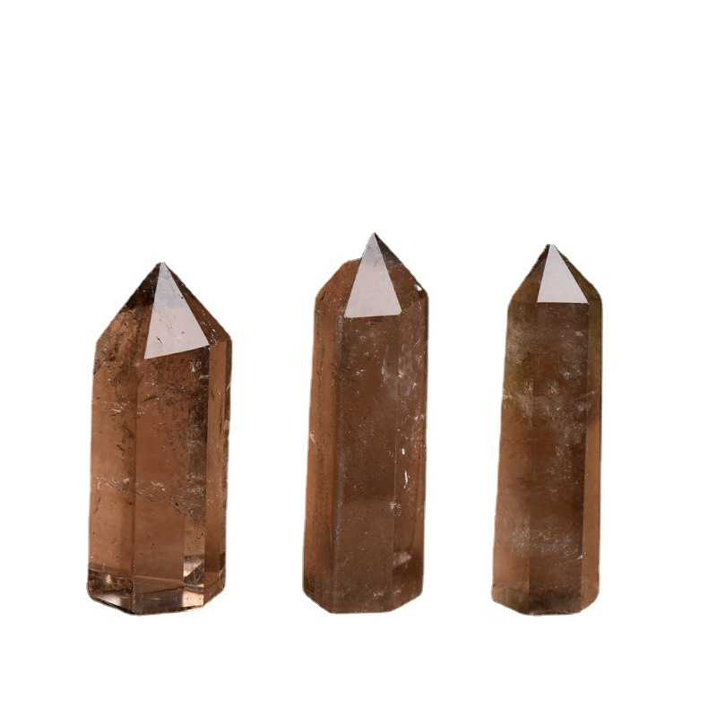 Three natural smoky quartz crystal point towers on white background, polished hexagonal pillars, grounding protection stones
