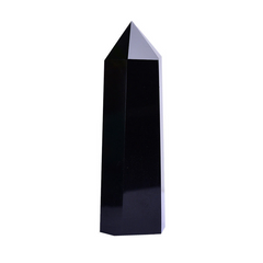 Polished black obsidian crystal point tower, single hexagonal pillar on white background, protection energy shield stone