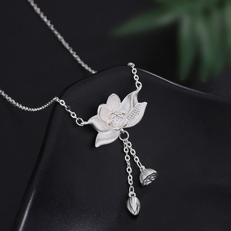 999 Silver Lotus Pod Necklace – Three-dimensional lotus flower with seed pod drops on black display form, silver pendant